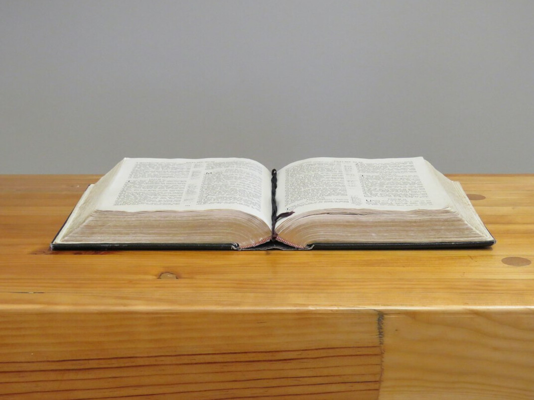 Open book with pages fanned out on a table