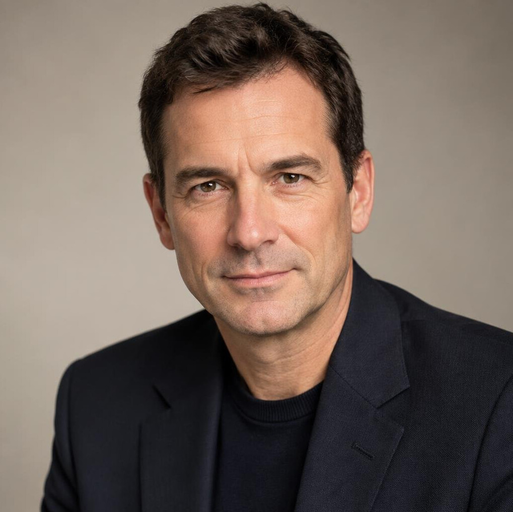 Portrait of a middle-aged man with short dark hair and a calm expression